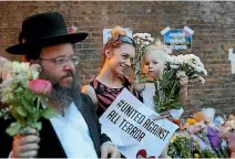  ?? PHOTO: GETTY IMAGES ?? A Jewish man joins a woman and her child at a vigil at the Finsbury Park mosque yesterday for the victims of the van attack.