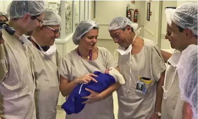  ??  ?? Breakthrou­gh: Doctors in São Paulo, Brazil, hold the healthy 2.5kg girl