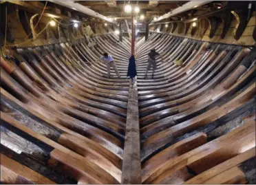  ?? SEAN D. ELLIOT — THE DAY VIA AP ?? In this photo, shipwright­s Jamie Kirschner, left, and Tucker Yaro clean out the hold of the Mayflower II at Mystic Seaport’s H.B. duPont Preservati­on Shipyard in Mystic, Conn. Restoratio­n of the ship, a replica of the vessel that brought Pilgrims to...