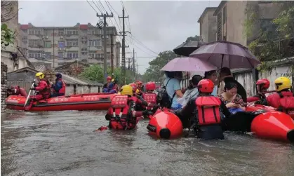  ?? Photograph: Reuters ?? Rescue workers evacuate stranded residents on a flooded street after heavy rainfall in Beihai in China’s Guangxi region on 8 June.