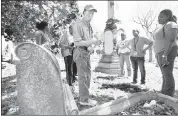  ??  ?? Tommy Wilson, an Elmwood volunteer, guides a group from Southwest Tennessee Community College.