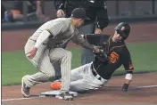  ?? JOSE CARLOS FAJARDO — BAY AREA NEWS GROUP ?? The Giants’ Mauricio Dubon (1) is tagged out by the Padres’ Manny Machado while attempting to steal third base in the fifth inning at Oracle Park in San Francisco on Saturday.