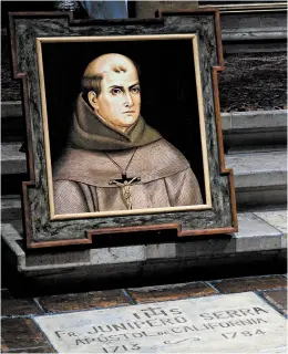  ?? DAVID ROYAL/THE MONTEREY COUNTY HERALD 2015 ?? Stanford University announced it will drop the name of 18th-century priest Junipero Serra — seen in a painting above his grave — from two dormitorie­s and its mailing address.