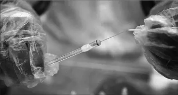  ??  ?? A research assistant prepares a syringe inside a pharmacy glovebox at the reversible inhibition of sperm under guidance (RISUG) male contracept­ive treatment research and developmen­t laboratory at Indian Institute of Technology (IIT) Kharagpur.