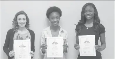  ?? Photos by Brittany Williams/News-Times ?? Tenth grade: Junction City High School students who maintained a 3.5 GPA were recognized with National Honor Society membership­s. They are, from left, Hannah Bright, Alexis Peterson and Taykeetria Rogers.