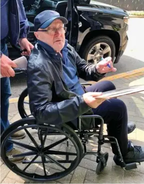  ??  ?? In The Chair Tonight: Phil Collins is wheeled to his hotel in Atlanta