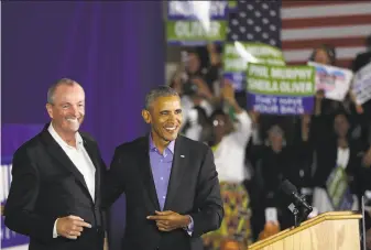  ?? Spencer Platt / Getty Images ?? Former President Barack Obama campaigns with Democratic candidate Phil Murphy, who is running for governor of New Jersey. Democrats hope his appearance will help unify the party.