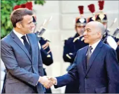  ?? AFP ?? Macron shakes hands with King Norodom Sihamoni at the Elysee Palace in the French capital Paris on November 13, 2023.
