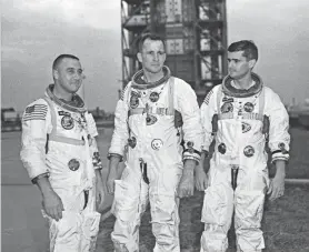  ?? COURTESY OF NASA ?? Apollo 1 astronauts, from left, Virgil “Gus” Grissom, Edward White II, and Roger Chaffee pose next to their Saturn 1 launch vehicle in this Jan. 17, 1967, photo at Launch Complex 34 at Cape Canaveral Air Station in Cape Canaveral, Fla.