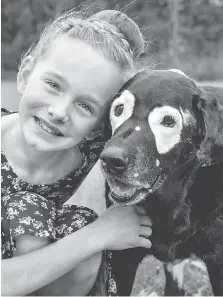  ??  ?? London’s Ava Bright travelled to Oregon recently to meet a dog named Rowdy, a Labrador retriever that shares the same skin condition.