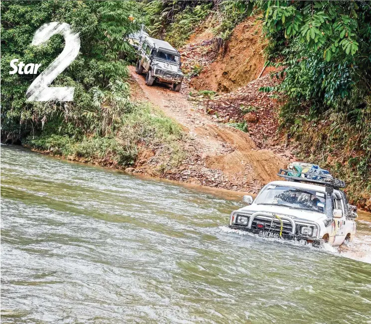  ??  ?? Crossing a river during the Sarawak 4X4 Jamboree near Sri Aman. — PAUL SI