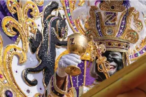  ?? ?? King of Zulu Nick Spears toasts from his float during the traditiona­l Krewe of Zulu Parade on Tuesday during Mardi Gras in New Orleans. (AP Photo/Gerald Herbert)