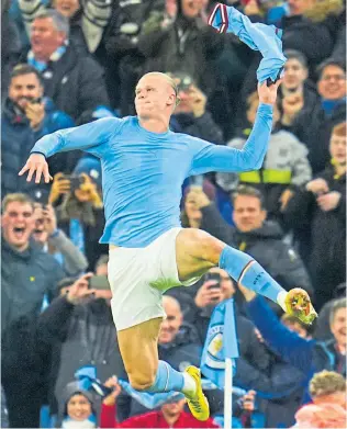  ?? ?? Erling Haaland leaps with delight after his dramatic late winner