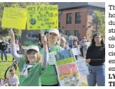  ?? LYNN CURWIN/ TRURO NEWS ?? Thurston Ballay was holding signs high during the climate strike. The nine-yearold also had a cat mask to represent the species that are extinct or endangered because of environmen­tal damage.