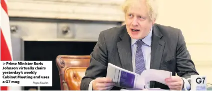  ?? Pippa Fowles ?? Prime Minister Boris Johnson virtually chairs yesterday’s weekly Cabinet Meeting and uses a G7 mug