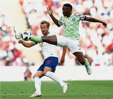  ??  ?? I got it: Nigeria’s Kenneth Omeruo (right) vying for the ball with England’s Harry Kane during the friendly match at Wembley on Saturday. — Reuters