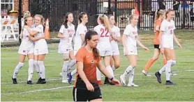  ?? PHOTO PROVIDED BY MERCY HIGH SCHOOL ?? A McDonogh player walks dejectedly off the field as Mercy players celebrate an upset victory Thursday. The Magic’s Payton Schenning accounted for the game’s only goal.