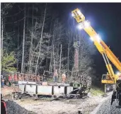  ??  ?? Um kurz nach ein Uhr rauschte der letzte Zug über die Brücke.
danach konnte verladen werden.
Das gelbe Ungetüm transporti­erte das künftige Denkmal über die Müngstener Brücke zum Bahnhof Schaberg.