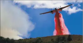  ?? KENT PORTER — THE PRESS DEMOCRAT ?? A Cal Fire air tanker helps stop the spread of a fire in Larkfield on Thursday.