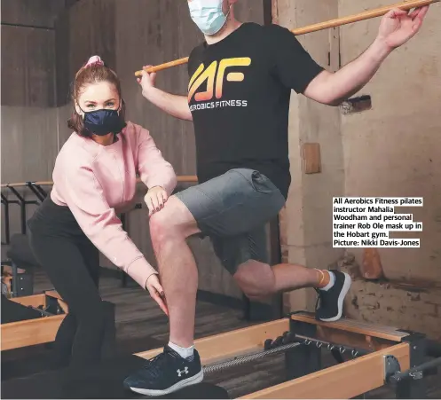  ?? ?? All Aerobics Fitness pilates instructor Mahalia Woodham and personal trainer Rob Ole mask up in the Hobart gym. Picture: Nikki Davis-Jones