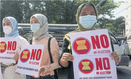  ?? AFP ?? Protesters hold signs as they take part in a demonstrat­ion against the military coup in Yangon on Wednesday.