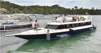  ?? — AFP ?? Tourists prepare to leave Bali for a neighbouri­ng island by boat from Padangbai harbour in Karangasem Regency on Indonesia’s resort island of Bali on Wednesday.