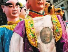  ??  ?? Left: Tat Wong Kung Fu Academy student Seth Hong gets ready to march. Right: Ben Wu dresses up as one of the Eight Immortals.