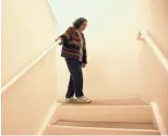  ?? ERIC RISBERG/ ASSOCIATED PRESS ?? Helen Wagar, who is in her 80s, walks over the spot in a stairway where she fell over another woman during the recent power blackouts Wednesday in Novato, Calif.