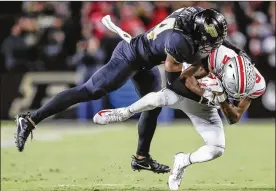  ?? MICHAEL HICKEY / GETTY IMAGES ?? Ohio State’s Binjimen Victor is tackled by Perdue’s Antonio Blackmon after a reception in the Buckeyes’ loss on Saturday in West Lafayette, Indiana. Graduation, NFL early entries and injuries might have caught up with Ohio State.