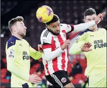  ??  ?? Sheffield United’s Jayden Bogle heads the ball between Newcastle’s Paul Dummett, left, and Ciaran Clark during the English Premier League soccer match between Sheffield United and Newcastle United at the Bramall Lane
stadium in Sheffield, England, on Jan 12. (AP)