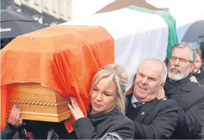  ?? Picture: PA. ?? Sinn Fein leader Michelle O’Neill, front, and the party’s president, Gerry Adams, back, help to carry the coffin of Mr McGuiness.