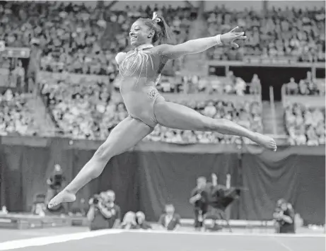  ?? Jeff Roberson / Associated Press ?? With a smile on her face, Simone Biles got her night off to a great start with an excellent performanc­e in the floor exercise.