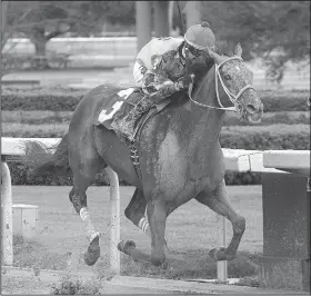  ?? The Sentinel-Record/RICHARD RASMUSSEN ?? Jockey Corey Lanerie guides Hawaakom across the wire to win the $500,000 Razorback Handicap at Oaklawn Park in Hot Springs on Monday. Hawaakom’s winning time was 1 minute, 45.14 seconds.