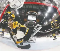  ??  ?? Boston defenceman Zdeno Chara sweeps the puck out of the crease from behind goalie Tuukka Rask in Game 7 of the 2019 Stanley Cup final against St. Louis. Rask appeared in all 24 playoff games for Boston last spring.