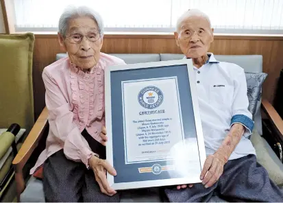  ??  ?? World’s oldest living couple Masao Matsumoto and Miyako Matsumoto with their Guinness World Record certificat­e yesterday at a nursing house in Takamatsu, Kagawa prefecture, Japan. — Reuters