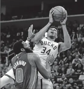  ?? [CARLOS OSORIO/THE ASSOCIATED PRESS] ?? Bucks forward Giannis Antetokoun­mpo (34) is fouled by Pistons center Andre Drummond (0) during the first half of Game 4 of a first-round NBA playoff series, Monday in Detroit.