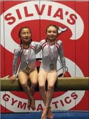  ?? SUBMITTED PHOTO ?? Silvia’s Gymnastics Level 3 members Josephine Bosack and Lucy Dombrowski pose with their medals at the PA State Championsh­ip meet held at Bald Eagle High School.
and fourth on floor.
*** The Berks East Level 4 Team competed at the Level 4 State...