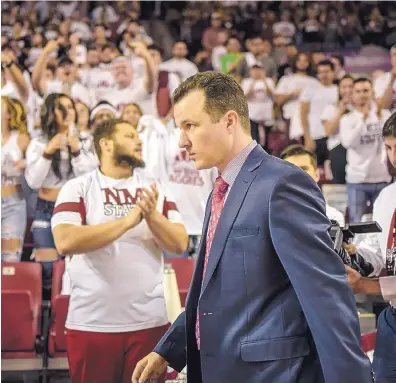  ?? ROBERTO E. ROSALES/JOURNAL ?? UNM coach Paul Weir is shown walking into the Pan American Center last season as fans boo the former Aggies boss in his return to New Mexico State. Weir is 0-3 as Lobos coach against the Aggies.