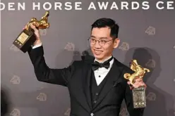  ?? ?? Malaysian director Lau Kok-rui poses for pictures after winning the Best Original Screenplay and the Best New Director awards.