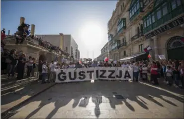  ?? RENE ROSSIGNAUD — THE ASSOCIATED PRESS ?? A banner reading “justice” opens a rally in Malta to honor an anti-corruption reporter Daphne Caruana Galizia, killed by a car bomb on Oct. 16, in the capital city of Malta, Valletta, Sunday.