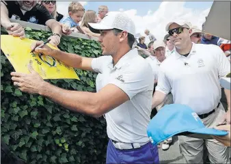  ?? [ADAM CAIRNS/DISPATCH] ?? Jason Day signs autographs at Muirfield Village Golf Club on Wednesday.