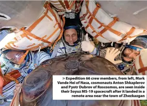  ?? ?? Expedition 66 crew members, from left, Mark Vande Hei of Nasa, cosmonauts Anton Shkaplerov and Pyotr Dubrov of Roscosmos, are seen inside their Soyuz MS-19 spacecraft after it landed in a remote area near the town of Zhezkazgan