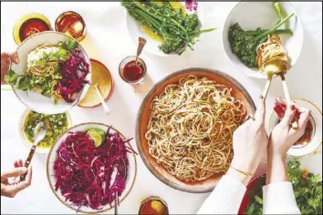  ??  ?? Cold chile noodles, served with fresh herbs, citrusy cabbage, and vegetables, are an easy option for fancy entertaini­ng.