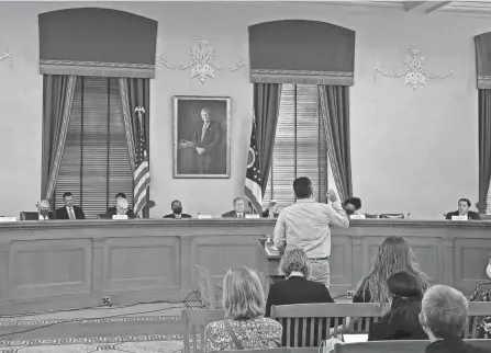  ?? KYLE ROBERTSON/COLUMBUS DISPATCH ?? The Ohio Redistrict­ing Commission listens to an Ohioan voice his concern over the Ohio House and Senate district draft maps during a meeting at the Ohio Statehouse in Columbus on Thursday.