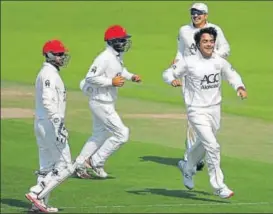  ?? GETTY IMAGES ?? Rashid Khan (right) has become the face of Afghanista­n cricket.