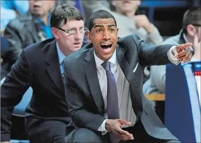  ?? FRED BECKHAM/AP PHOTO ?? UConn coach Kevin Ollie, right, gestures during a game against Rutgers on March 5, 2014. Assistant coach Glen Miller is at left.