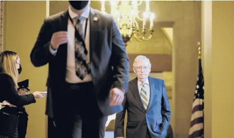  ?? T.J. KIRKPATRIC­K/THE NEW YORK TIMES ?? Senate Minority Leader Mitch McConnell walks to the Senate chamber on Wednesday.