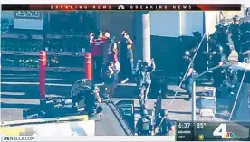  ?? KNBC-TV ?? Hostages and a suspect leave a Trader Joe’s supermarke­t Saturday in the Silver Lake district of Los Angeles as Los Angeles Police officers close in at right.