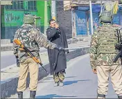  ??  ?? Soldiers stop a pedestrian in Srinagar, where restrictio­ns were imposed on Friday.