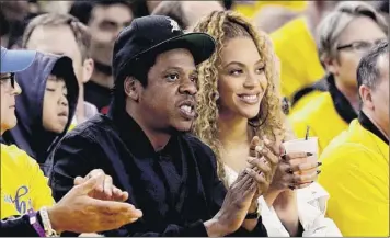  ?? Marcio Jose Sanchez / Associated Press ?? Jay-z and Beyonce watch a 2018 NBA playoff game in Oakland, Calif. Musicians including Rihanna, Beyoncé, Taylor Swift, Lil Nas X, Demi Lovato, Post Malone and Harry Styles have spoken out following the death of George Floyd and the worldwide demonstrat­ions.